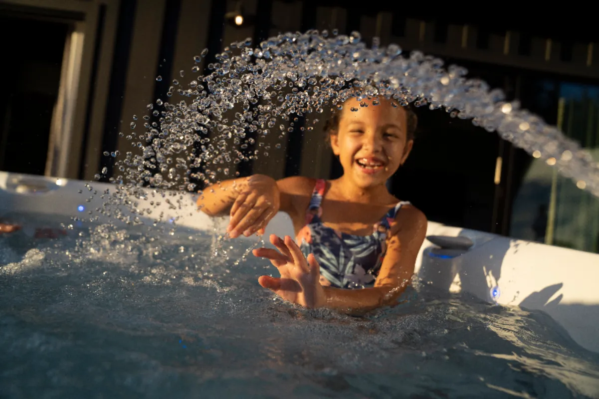 Young girl playing in a hot tub